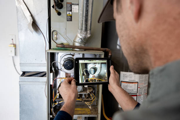 certified HVAC technician diagnosing furnace issues indoors