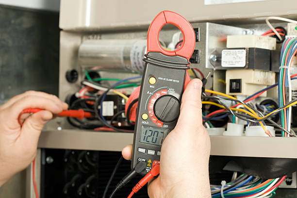 professional furnace repair technician adjusting heating components